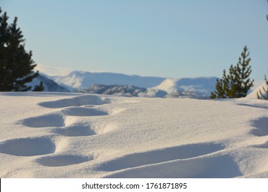 Footsteps In The Arctic Snow. Komsatoppen In Alta, Norway With Blue Sky And Sun.