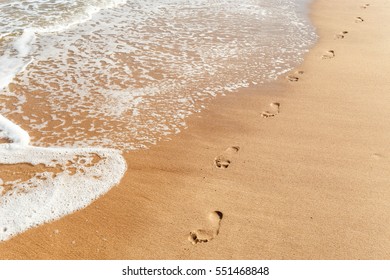 Footsteps On The Evening Beach