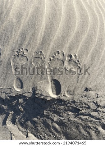 Footsteps on the sand beach.