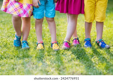 Footwear for children. Group of preschool kids wearing colorful leather shoes. Sandal summer shoe for young child and baby. Preschooler playing outdoor. Child clothing, foot wear and fashion. - Powered by Shutterstock