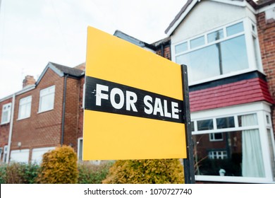 'For Sale' Sign Outside Of A Terraced House In The UK. 