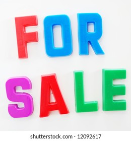 'For Sale' Written On Fridge Door With Fridge Magnet Alphabet Letters.