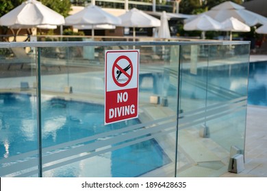 Forbidden Sign No Diving Hangs On Glass Fence Near Swimming Pool Outside