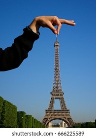 Forced Perspective Of A Hand Taking The Eiffel Tower