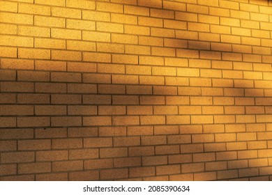 Forced Perspective Of Tan Brick Wall With Foliage Shadows 