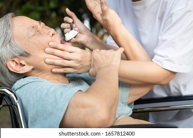 Force-feeding Because Asian Senior Woman Refuses,does Not Want To Eat Food,angry Female Caregiver Scolding,force Feeding A Meal For Elderly People,stop Physical Abuse,violence,aggression,coercion 