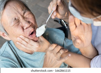 Force-feeding Because Asian Senior Woman Refuses,does Not Want To Eat Food,angry Female Caregiver Scolding,force Feeding A Meal For Elderly People,stop Physical Abuse,violence,aggression,coercion 
