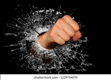 Forceful And Powerful Fist Breaking Through A Glass Barrier