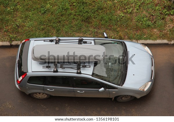 Ford Focus C-Max is compact multi-purpose vehicle\
(MPV) produced by Ford Motor Company. Car with luggage box Thule\
roof. american family multivin. Vehicle is parked on street. Moscow\
2013 trunk, boot
