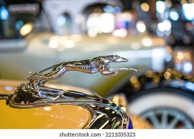 Ford Greyhound Hood Ornament On The Yellow Retro Car.