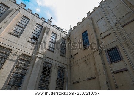 a foreboding building with sun shining over the corner at the Brushy Mountain State Penitentiary