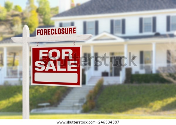 Foreclosure Home For Sale Real Estate Sign in\
Front of Beautiful Majestic\
House.