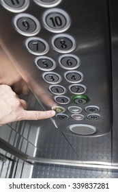 Forefinger Pressing The Alarm Button In The Elevator - Top Down View