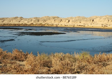 In The Foreground Is Completely Filled With Oil Sludge Pit.