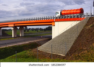 In The Foreground There Is A Bridge Abutment. Road Viaduct Over The Highway. 