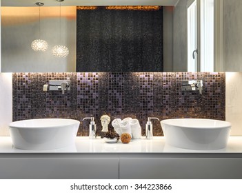 Foreground Of Two Washbasin With Mosaic Tiles And Large Mirror In The Modern Bathroom