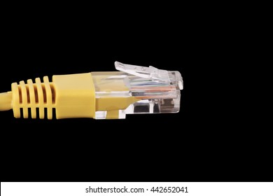 foreground  of a yellow network cable over black background