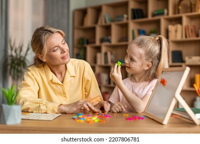 Foreign Language Classes For Preschoolers. Clever Pretty Kid Girl Learning Alphabet, Pronouncing And Making Words With Colorful English Letters On Board