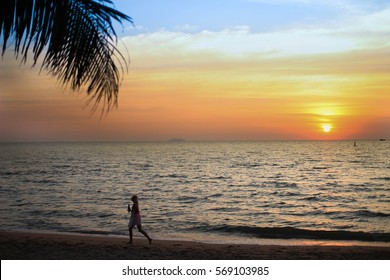 Foreigner Walk Along The Beach With Sun Set Sea View.