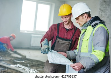 Foreman Builder And Construction Worker With Blueprint In Indoor Apartment