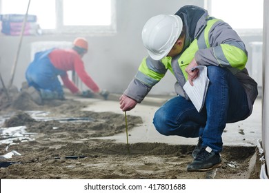 Foreman Builder Inspecting Concrete Construction Work In Apartment