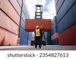 Foreman checking inventory or task details at Container cargo harbor. Logistics concept inside the shipping, import, and export industries.