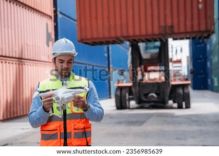 Foreman checking inventory or task details at Container cargo harbor. Logistics concept inside the shipping, import, and export industries.