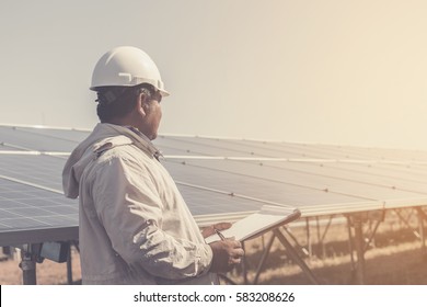 foreman checking job routine of labor working on cleaning solar panel at outside ; operation working on preventive and maintenance in solar power plant for great efficiency