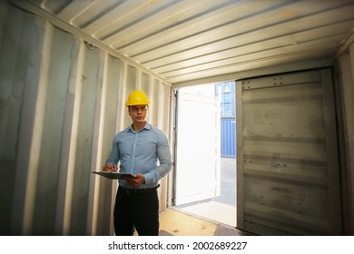 Foreman control cargo loading box. Logistics and transportation business. Industrial inspection of cargo containers. Engineer or foreman in red vest control loading containers boxes at cargo ship ber