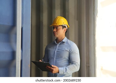 Foreman control cargo loading box. Logistics and transportation business. Industrial inspection of cargo containers. Engineer or foreman in red vest control loading containers boxes at cargo ship ber