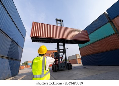 Foreman control folklife loading Containers box of goods in site from Cargo freight ship for import and export international 