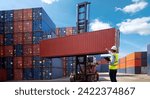 Foreman control loading Containers box from Cargo freight ship for import export  