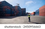 Foreman control loading Containers box from Cargo freight ship for import export  