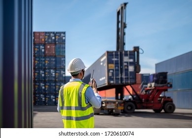 Foreman control loading Containers box to truck for Logistic Import Export Background, Business logistic concept, import and export concept