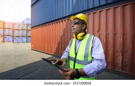 Foreman control loading Containers box from Cargo freight ship for import export.