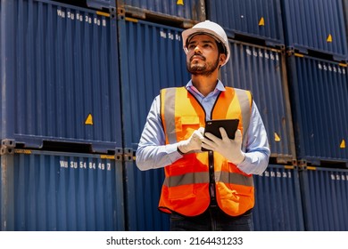 Foreman control loading containers box from factory to cargo freight ship. Container yard worker checking container at container yard warehouse. Shipping import export industry Logistics business.
