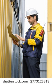 Foreman control loading containers box from factory to cargo freight ship. Container yard worker checking container at container yard warehouse. Shipping import export industry Logistics business.
