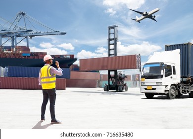 Foreman control loading Containers box from Cargo freight ship