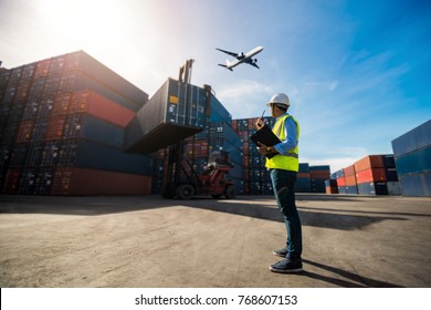 Foreman control loading Containers box to truck for Logistic Import Export Background, Business logistic concept, import and export concept - Shutterstock ID 768607153