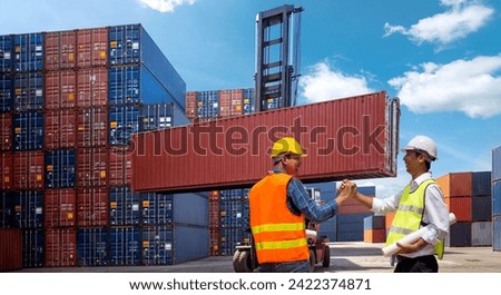 Foreman control loading Containers box from Cargo freight ship for import export  
