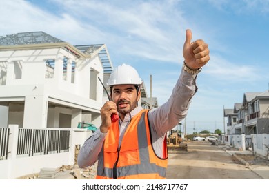 Foreman, An Engineer Holding  Walkie-talkie With A Radio, Talks To The Construction Crew On The House.