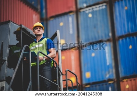 foreman or engineer are work in container shipping industry warehouse, logistic transport to import and export cargo at delivery storage port terminal, man are work to control a business box