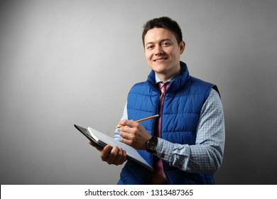 Foreman Holding Clipboard In His Hand At House, A Construction Inspector.