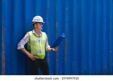Foreman holding document, walking and checking the containers box from cargo ship for export and import