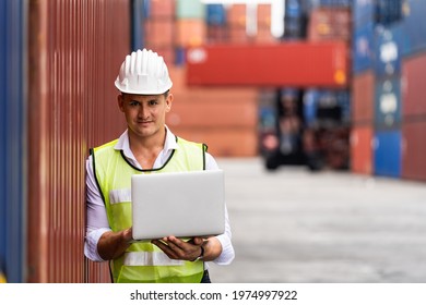 Foreman holding document, walking and checking the containers box from cargo ship for export and import