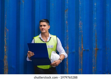Foreman holding document, walking and checking the containers box from cargo ship for export and import