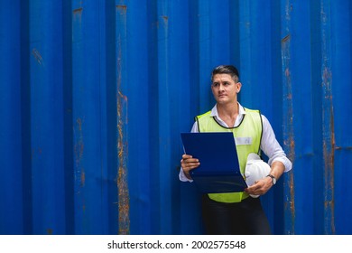 Foreman holding document, walking and checking the containers box from cargo ship for export and import