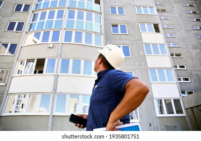foreman, an inspector examines the house for defects during the construction of a residential complex. - Shutterstock ID 1935801751