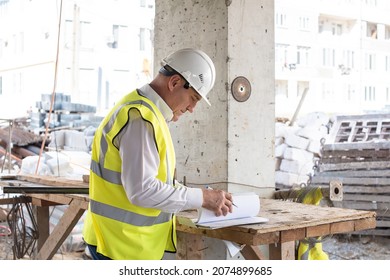 Foreman officer inspector, building Inspector, engineer or inspector at construction site checking and inspecting progressing work in construction site or building, in hardhat and high-visibility vest - Powered by Shutterstock