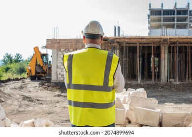 Foreman officer inspector, building Inspector, engineer or inspector at construction site checking and inspecting progressing work in construction site or building, in hardhat and high-visibility vest - Powered by Shutterstock